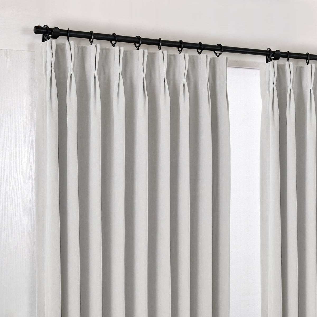 Genevieve Cloud-Soft Chenille Blackout Curtains in Chalk, hanging at the window