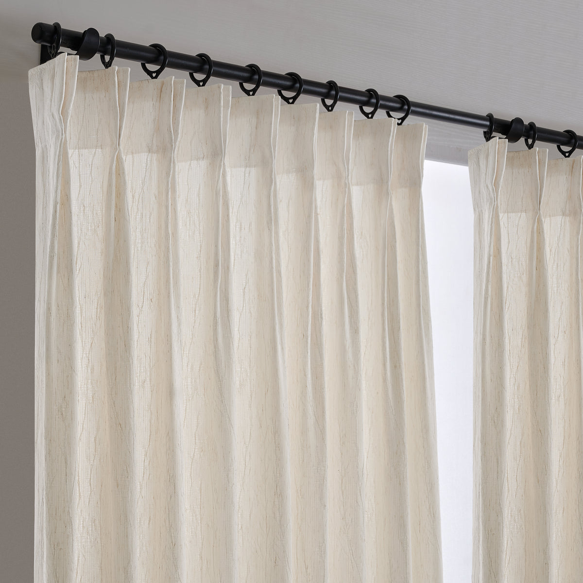 Odile Dandelion Sheer Curtains in Beige, hanging at the window