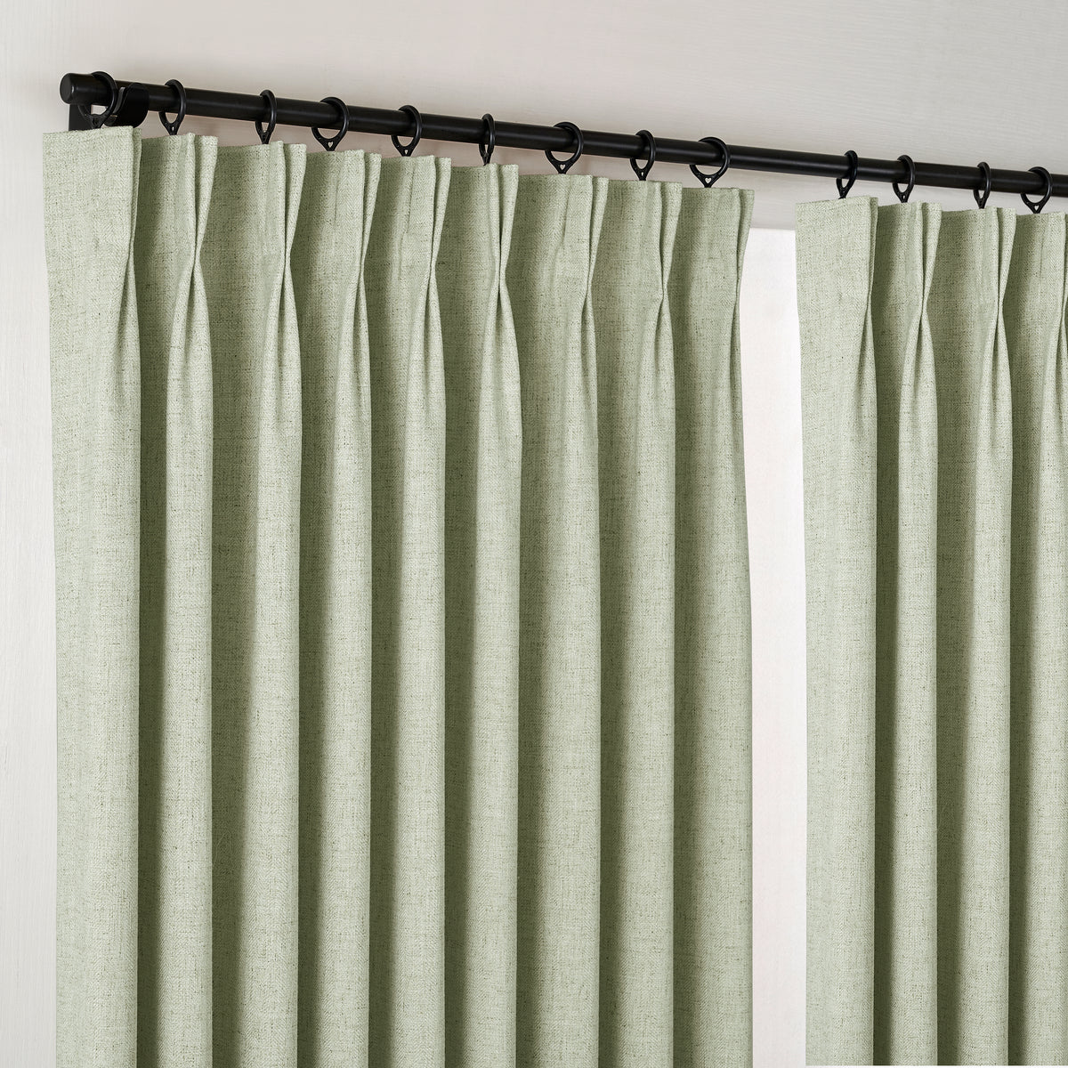 Forrester Linen-Blend Slub Curtains in Sage, hanging at the window