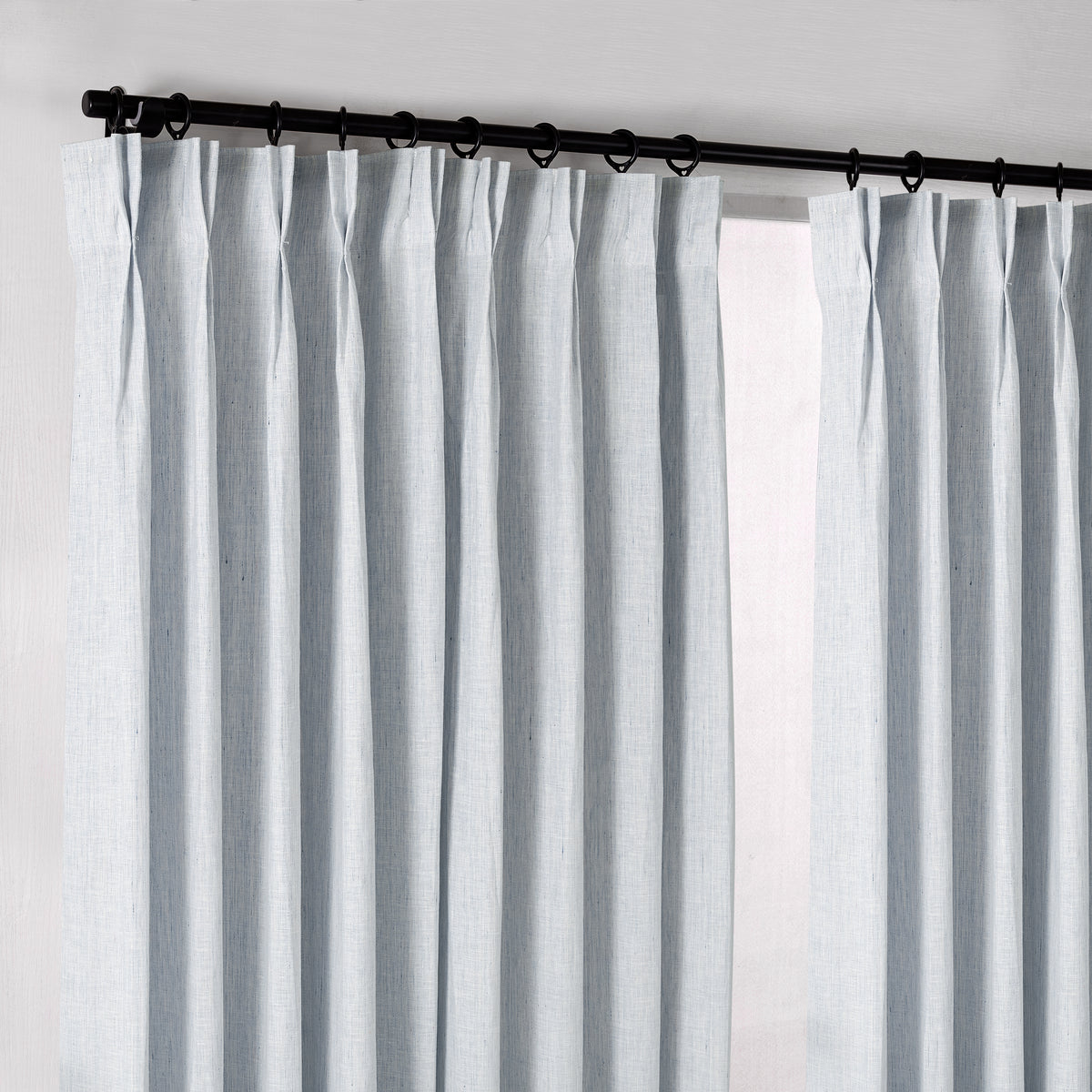 Rafe Slubbed Pure Linen Curtains in Chambray, hanging at the window