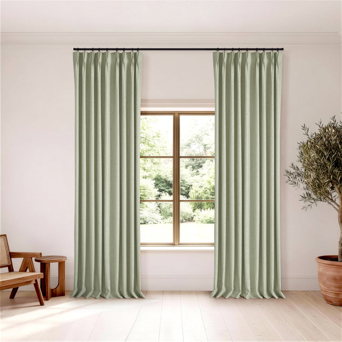 Forrester Linen-Blend Slub Curtains in Sage, hanging in a room