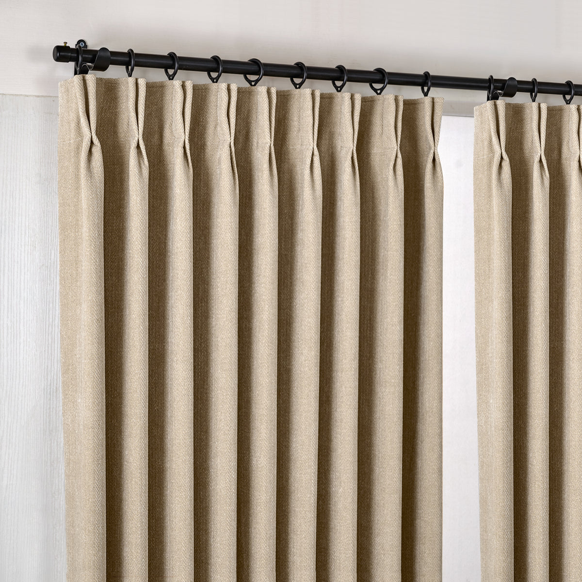 Hadleigh Herringbone Blackout Curtains in Flax, hanging at the window