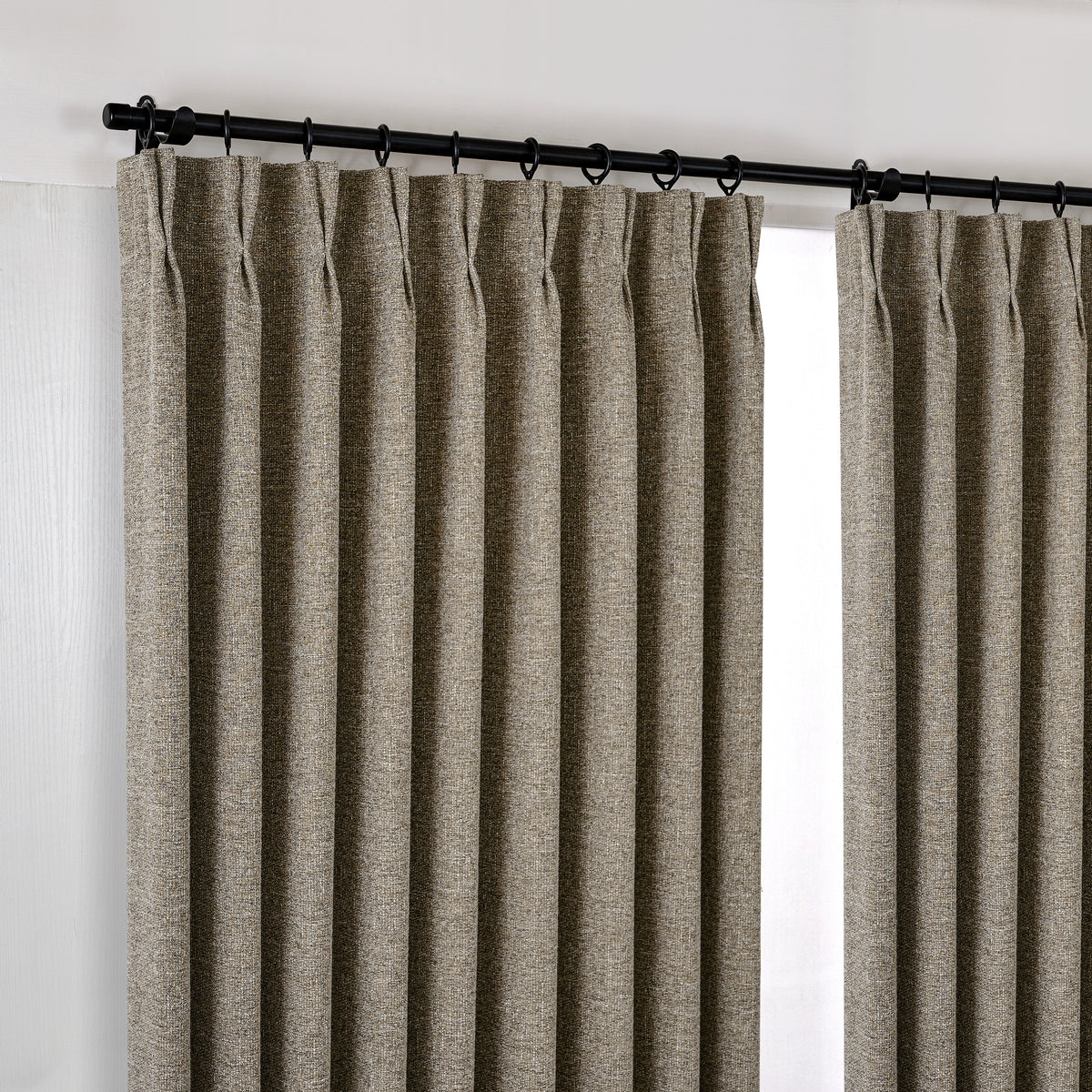 Tamsin Melange Weave Blackout Curtains in Stone, hanging at the window