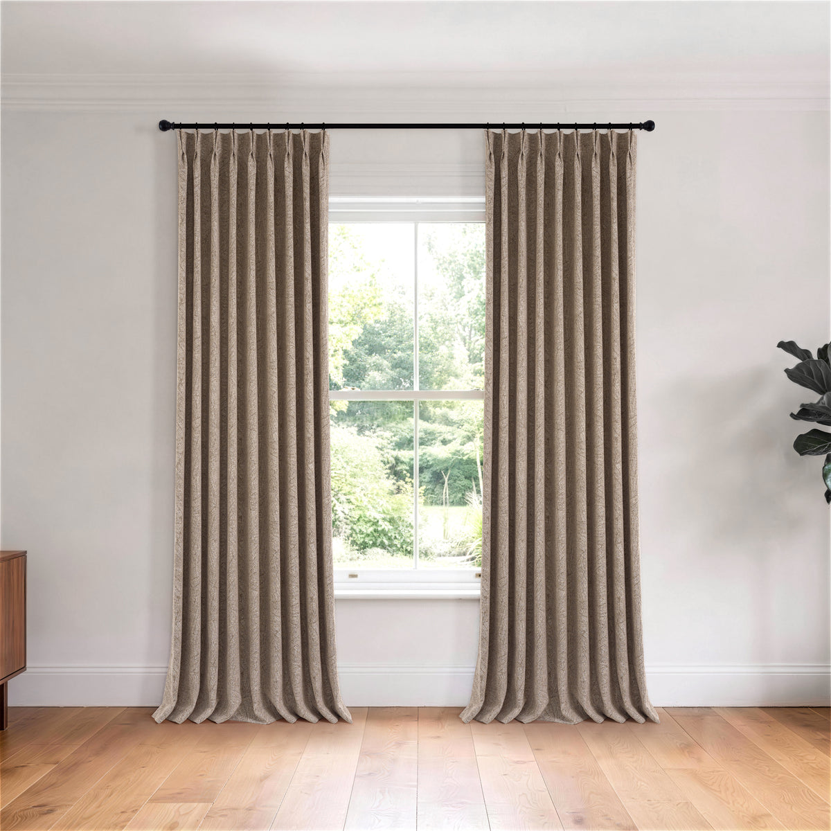 Bramwell Leaf Jacquard Blackout Curtains in Cocoa, hanging in a room