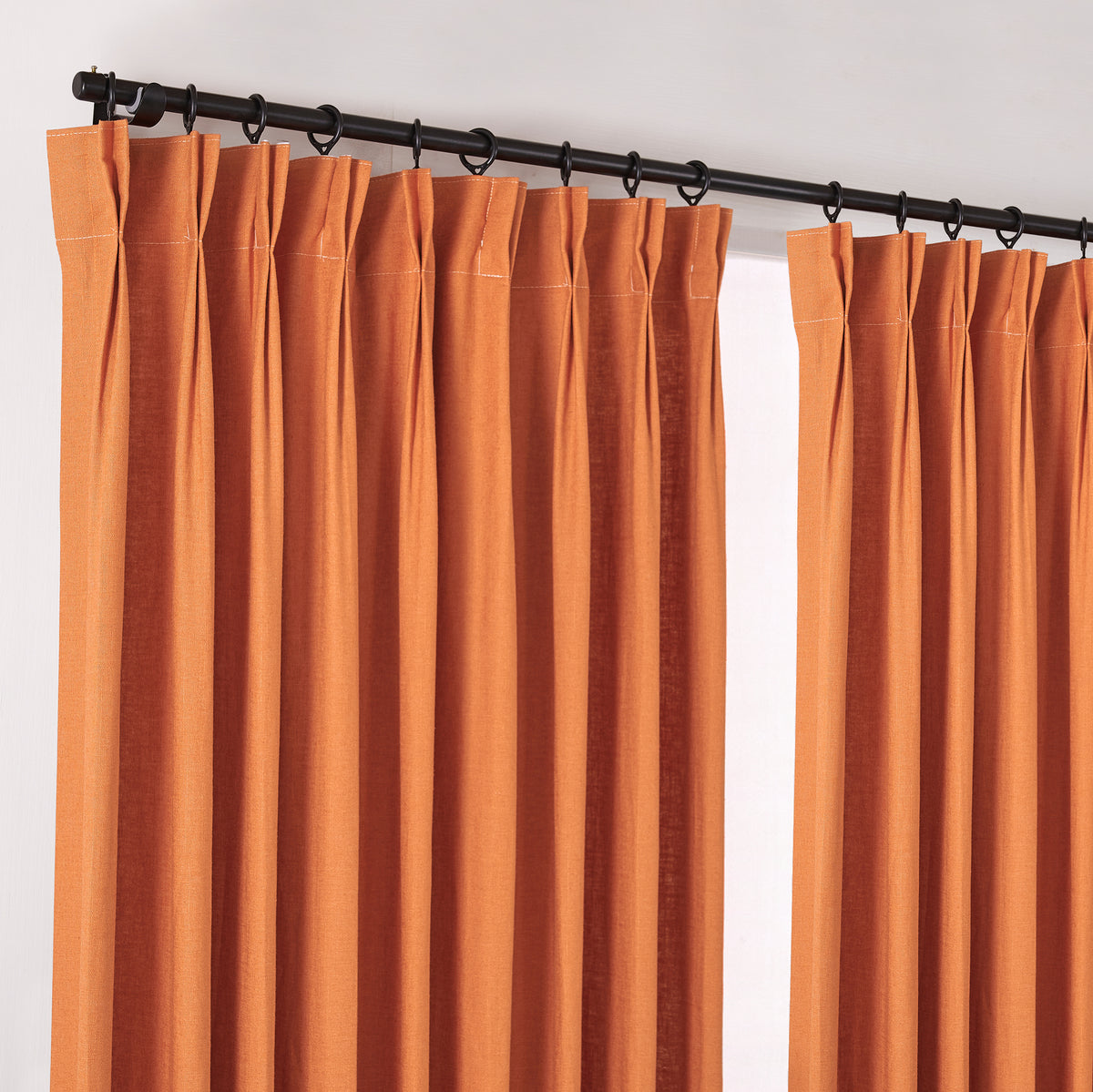 Edwina Linen-Cotton Curtains in Burnt Orange, hanging at the window