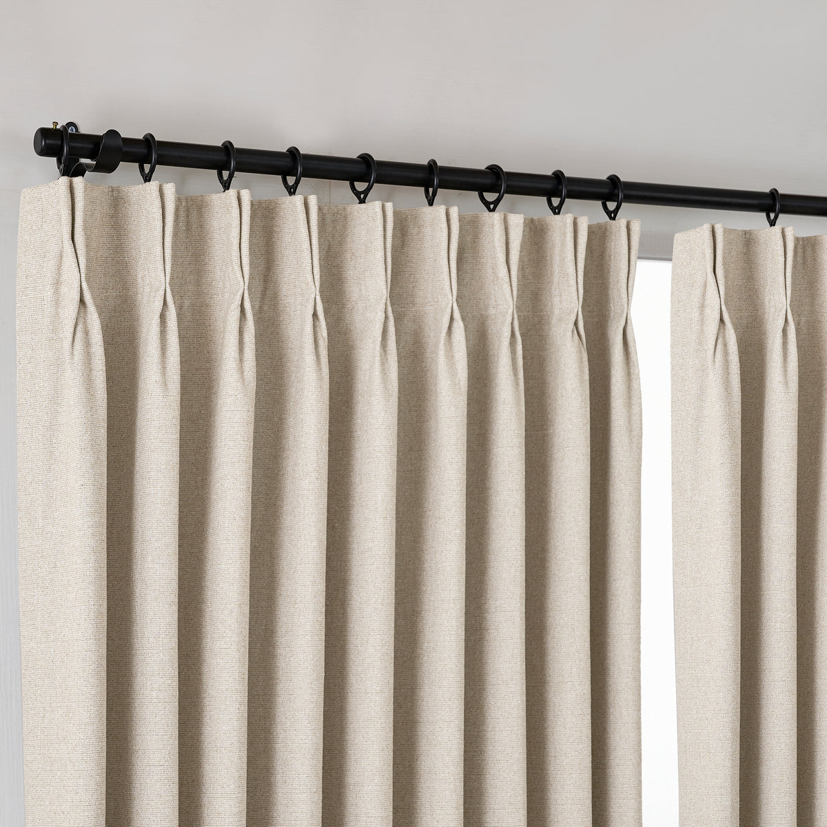 Fraser Wool-Blend Blackout Curtains in Oat, hanging at the window