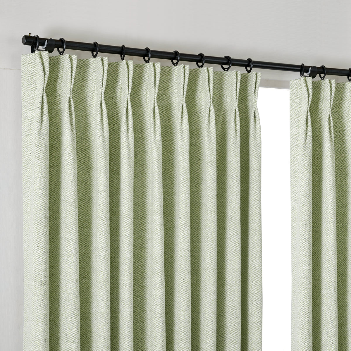 Pembroke Herringbone Weave Curtains in Pale Sage, hanging at the window