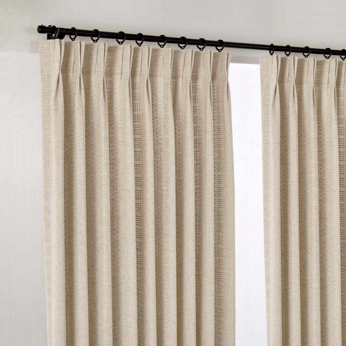 Ansel Eyelet Weave Curtains in Warm Greige, hanging at the window