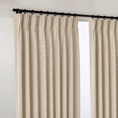 Ansel Eyelet Weave Curtains in Warm Greige, hanging at the window