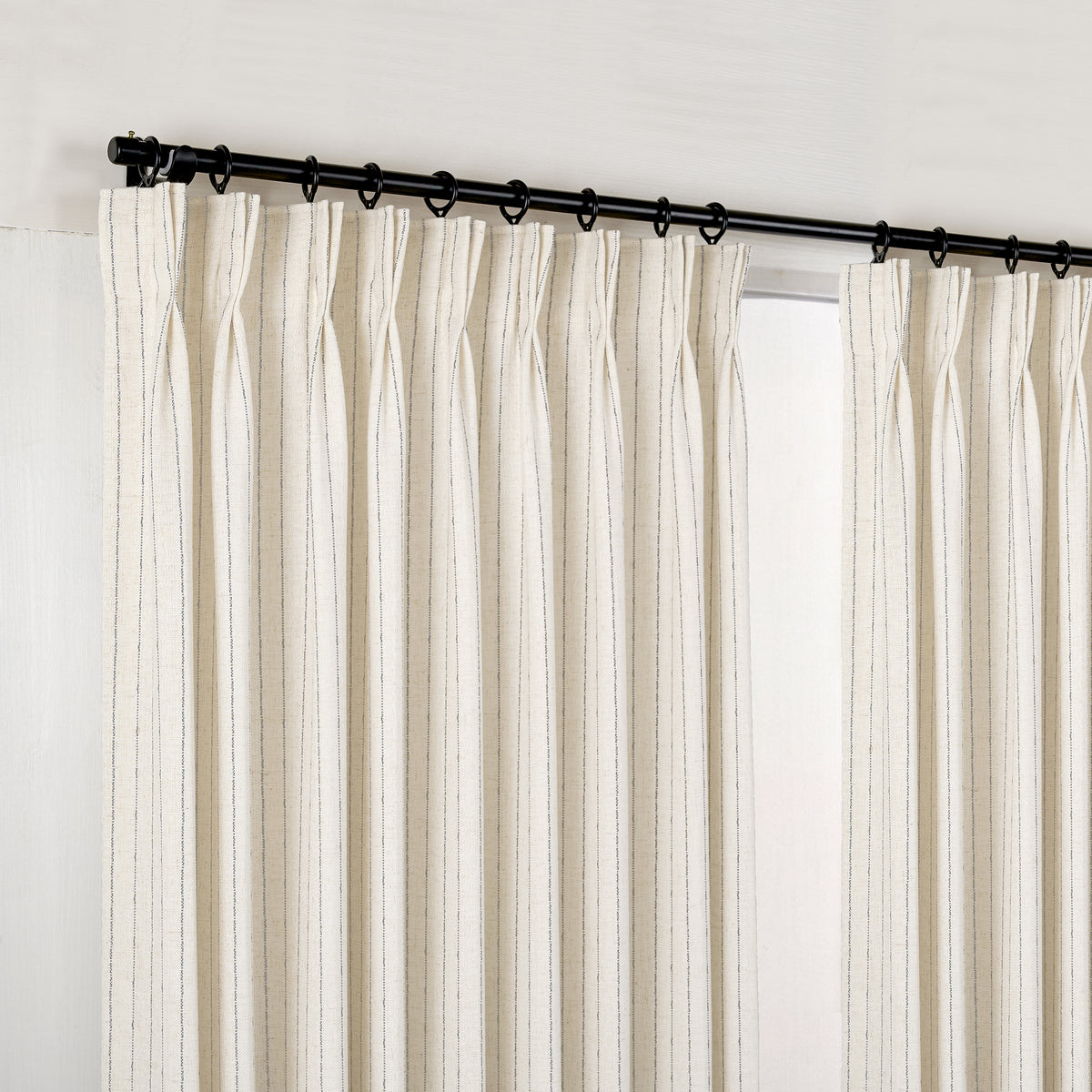 Ansel Pinstripe Weave Curtains in Cool Ivory, hanging at the window