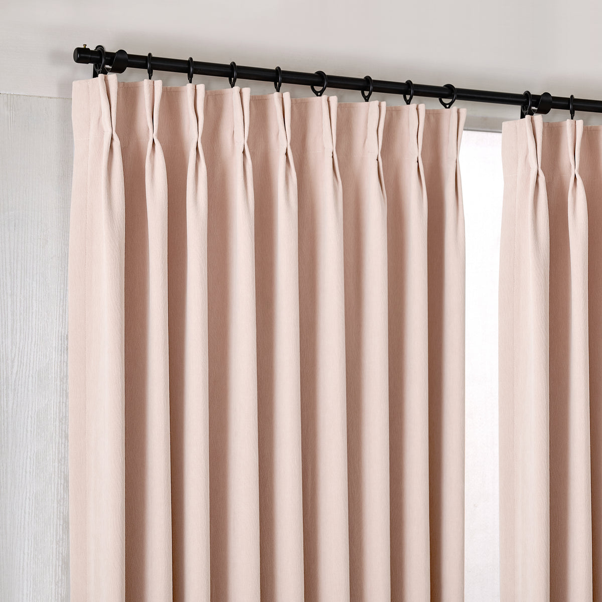 Ottilie Plush Chenille Blackout Curtains in Blush, hanging at the window