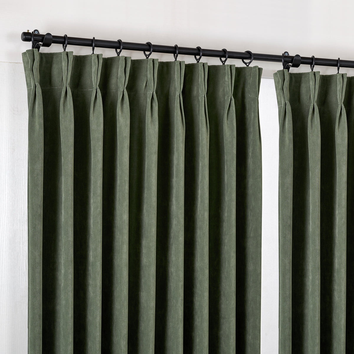 Genevieve Cloud-Soft Chenille Blackout Curtains in Forest, hanging at the window
