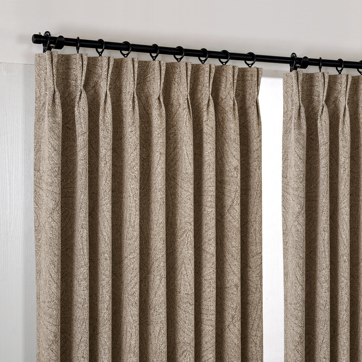 Bramwell Leaf Jacquard Blackout Curtains in Cocoa, hanging at the window