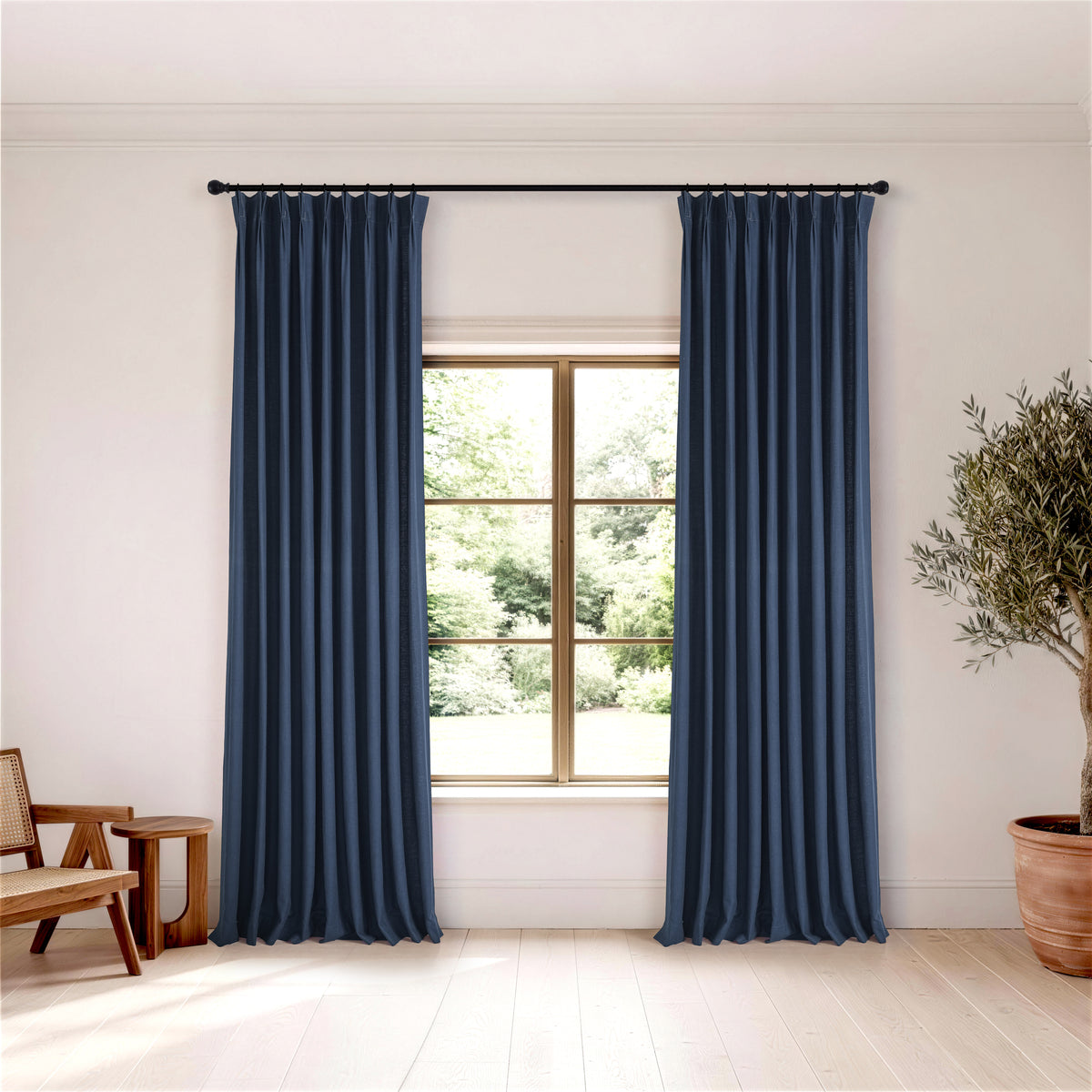 Edwina Linen-Cotton Curtains in Navy, hanging in a room