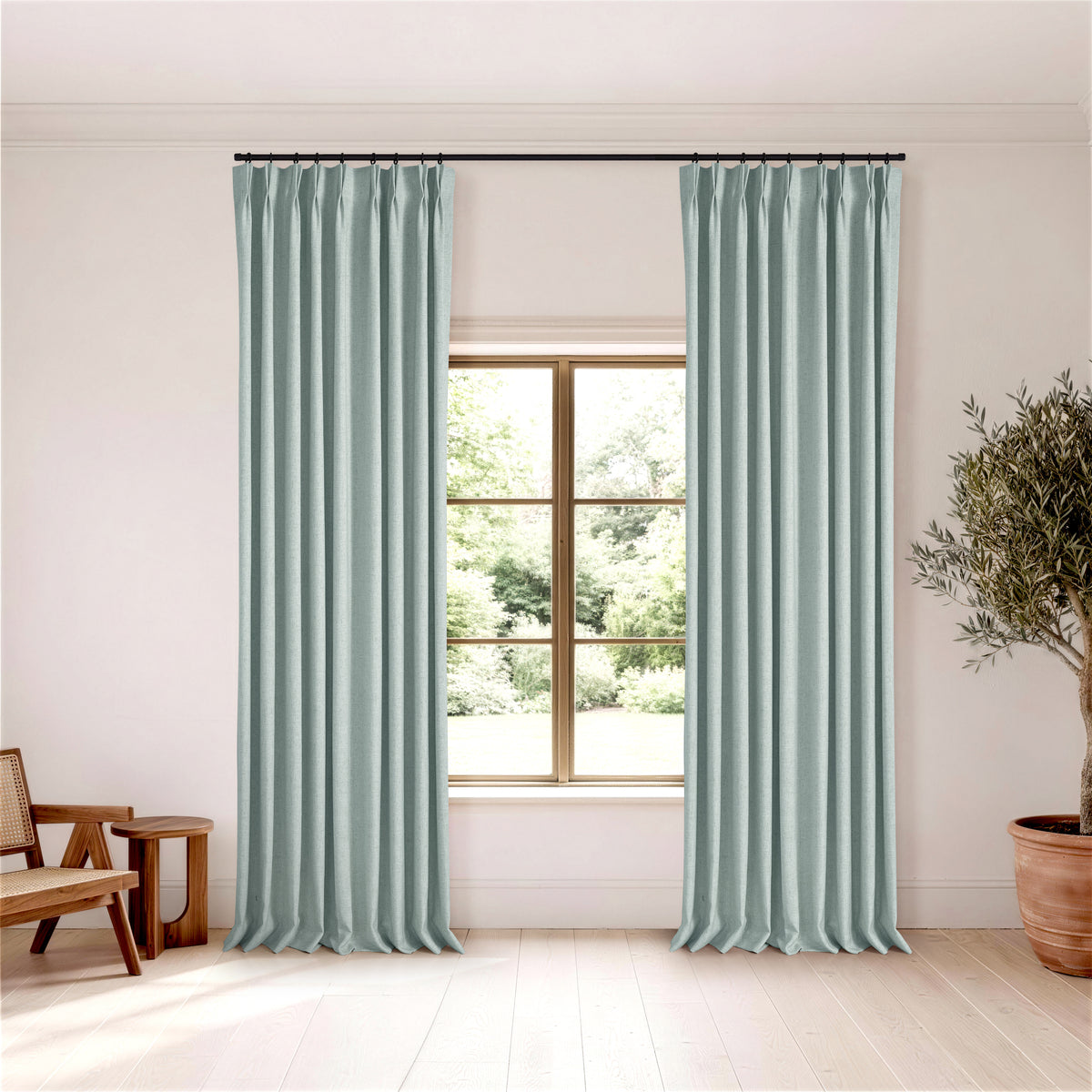 Forrester Linen-Blend Slub Curtains in Dusty Blue, hanging in a room