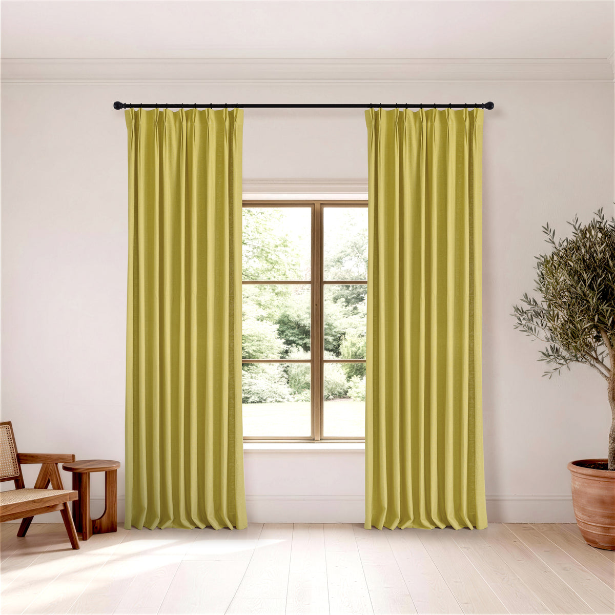 Edwina Linen-Cotton Curtains in Chartreuse, hanging in a room