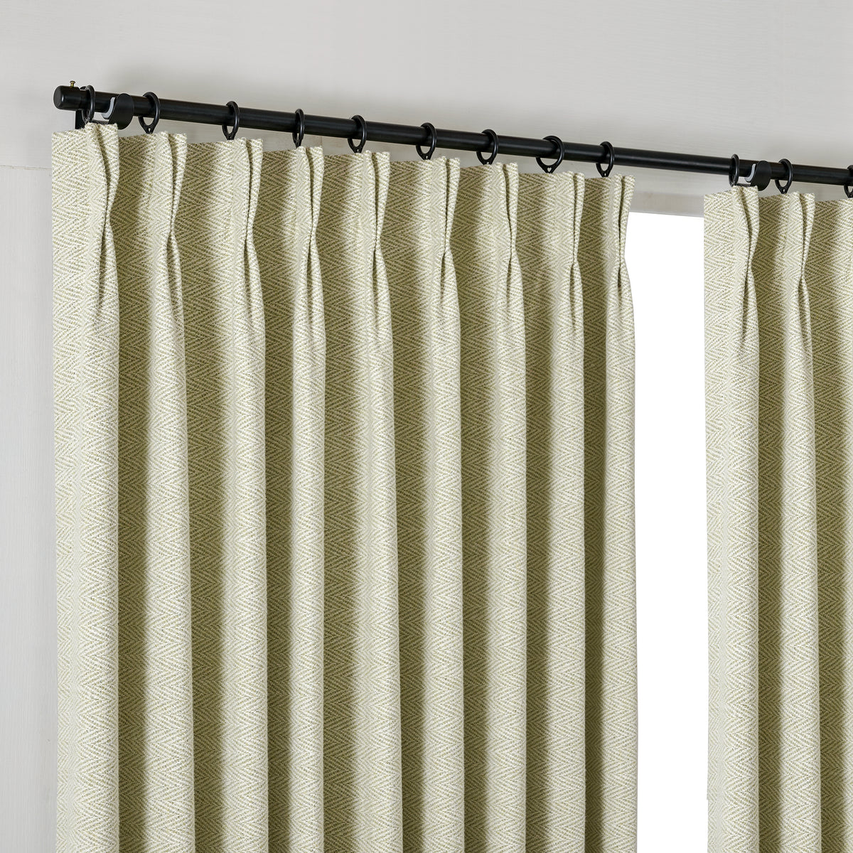 Pembroke Herringbone Weave Curtains in Pale Olive, hanging at the window