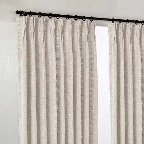 Ansel Eyelet Weave Curtains in Pale Greige, hanging at the window