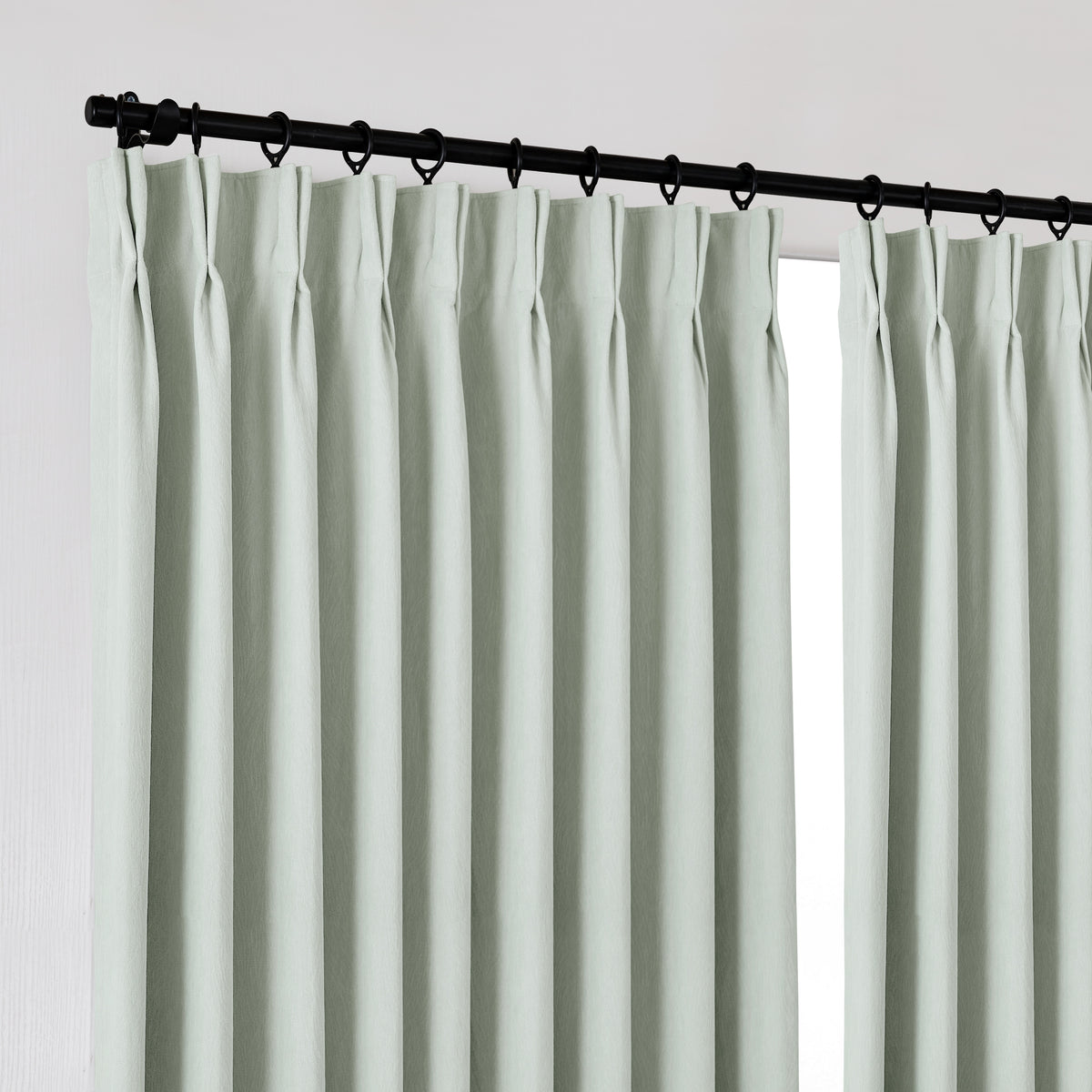 Ottilie Plush Chenille Blackout Curtains in Mint, hanging at the window