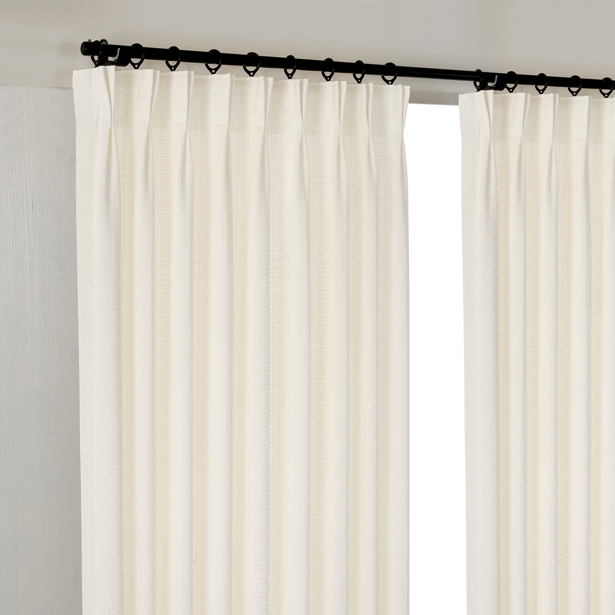 Ansel Eyelet Weave Curtains in Chalk, hanging at the window