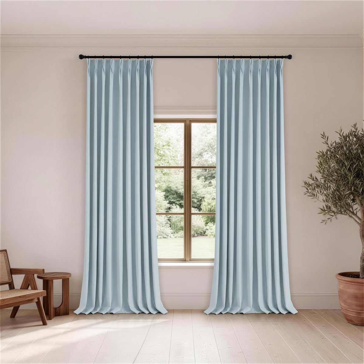 Cordelia Sculpted Chenille Blackout Curtains in Dusty Blue, hanging in a room