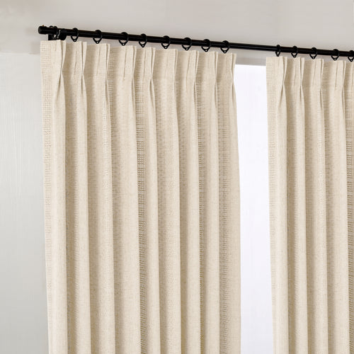 Ansel Eyelet Weave Curtains in Oat, hanging at the window
