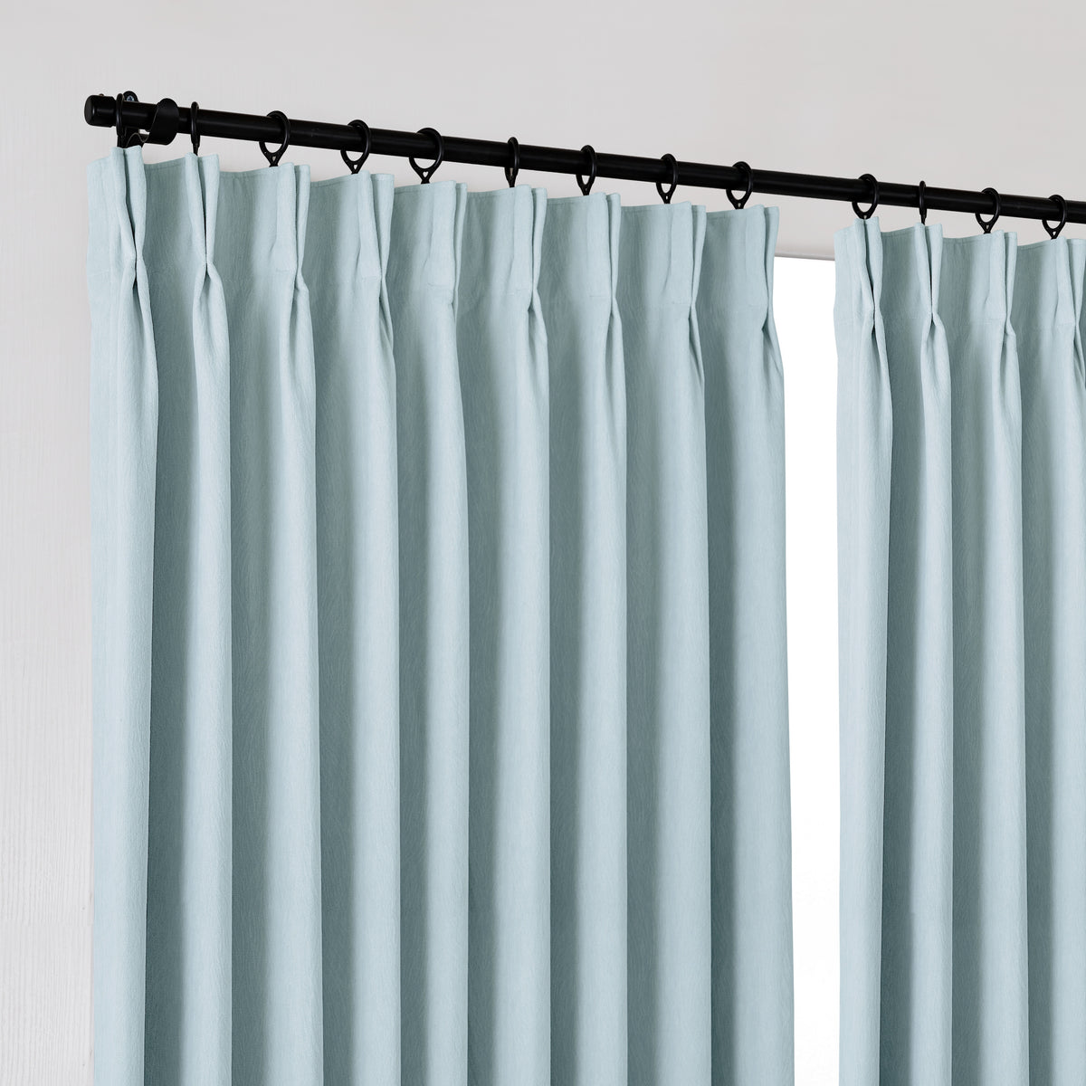 Ottilie Plush Chenille Blackout Curtains in Powder Blue, hanging at the window