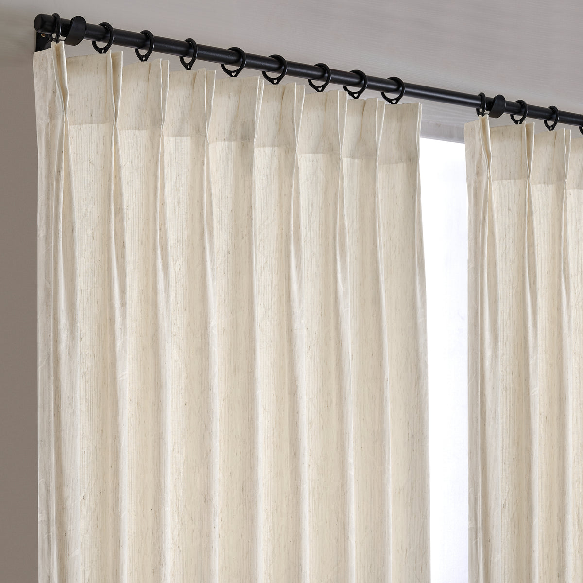 Odile Reed Sheer Curtains in Beige, hanging at the window