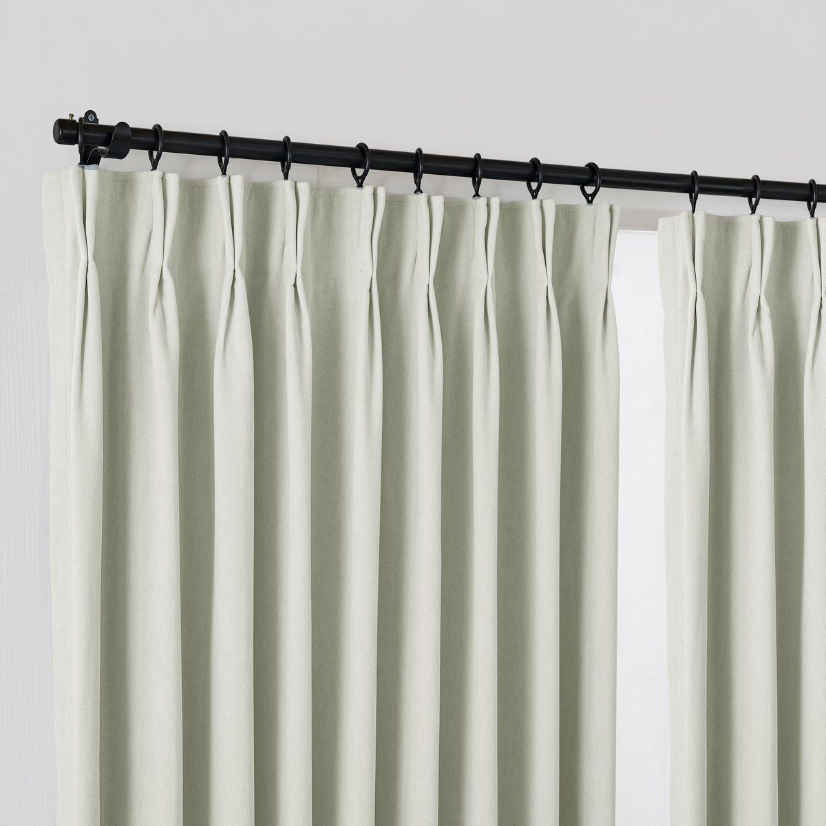 Ingram Brushed Weave Blackout Curtains in Mint, hanging at the window