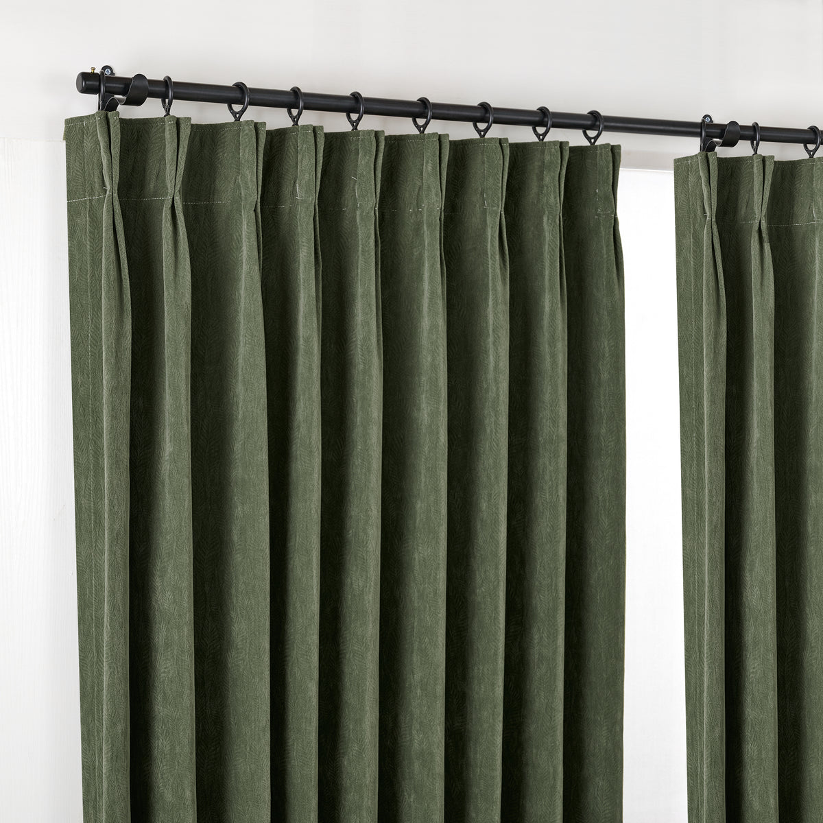 Cordelia Sculpted Chenille Blackout Curtains in Forest, hanging at the window