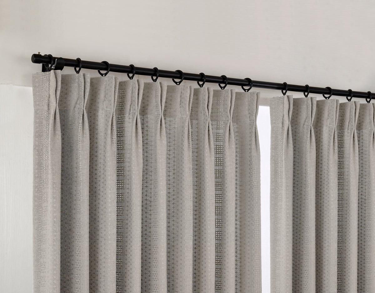 Ansel Eyelet Weave Curtains in Pewter, hanging at the window