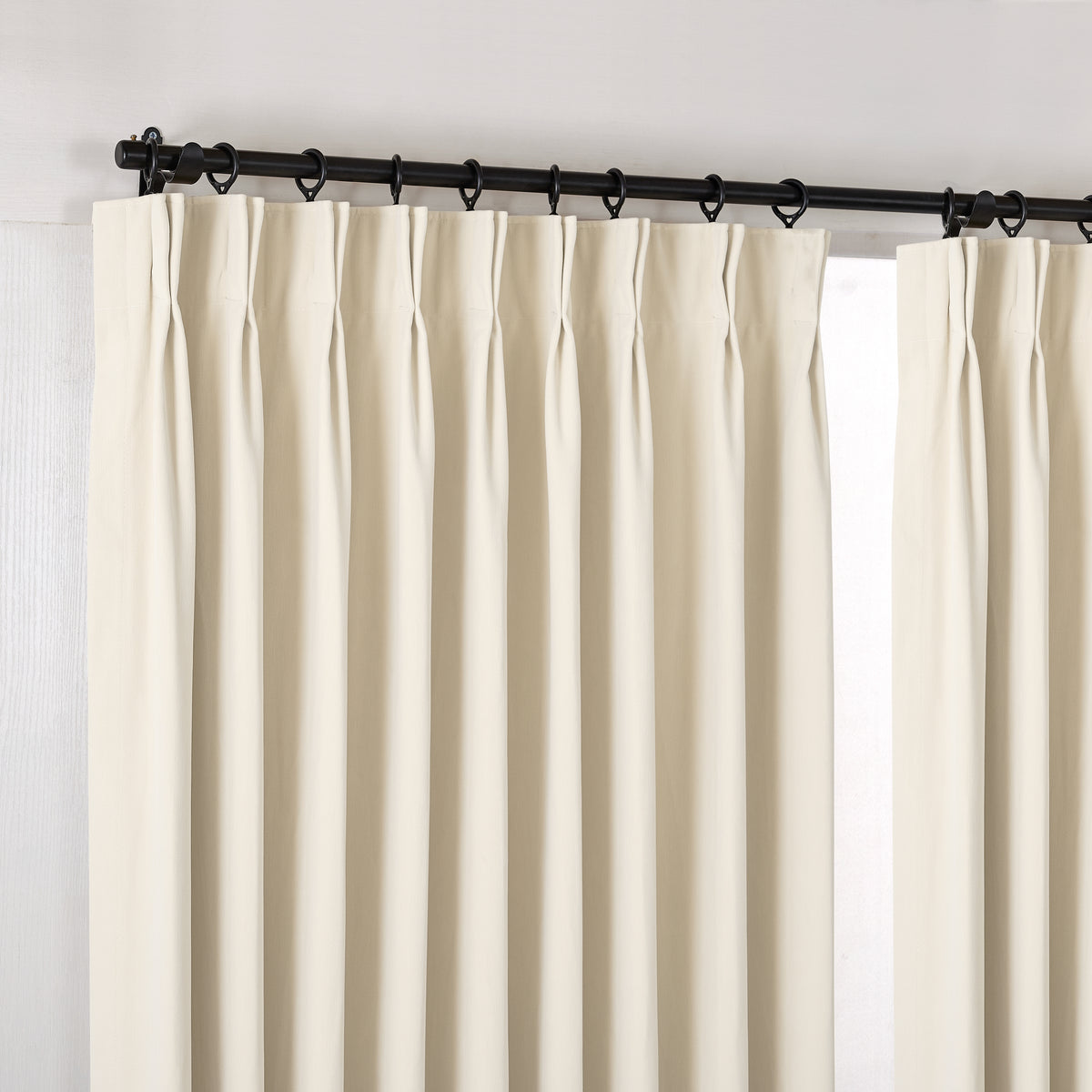 Sebastian Double-Faced Velvet Blackout Curtains in Ivory, hanging at the window