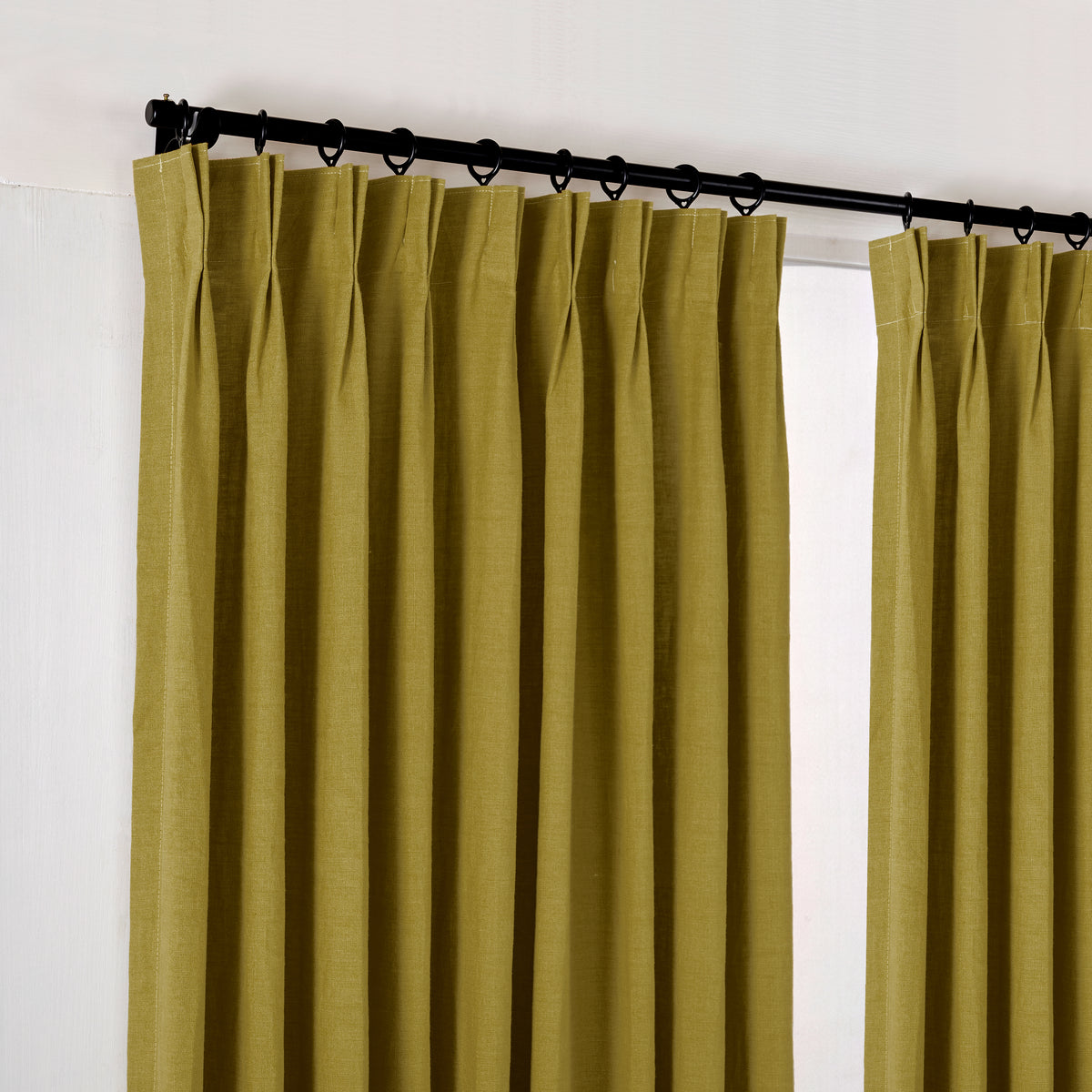 Ainsley Pure Linen Curtains in Olive, hanging at the window